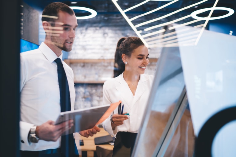 Team discusses public sector IT strategy in front of computer monitor